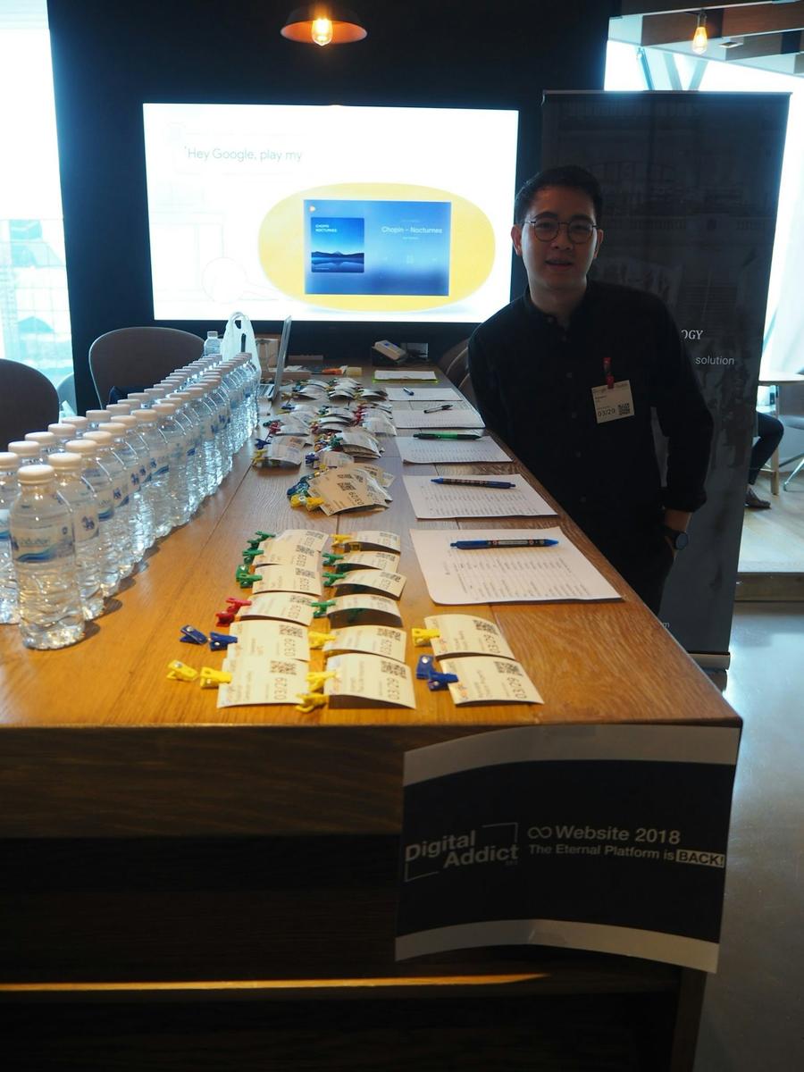 Attendees registering at a welcoming conference desk with friendly staff and blue medical banners.
